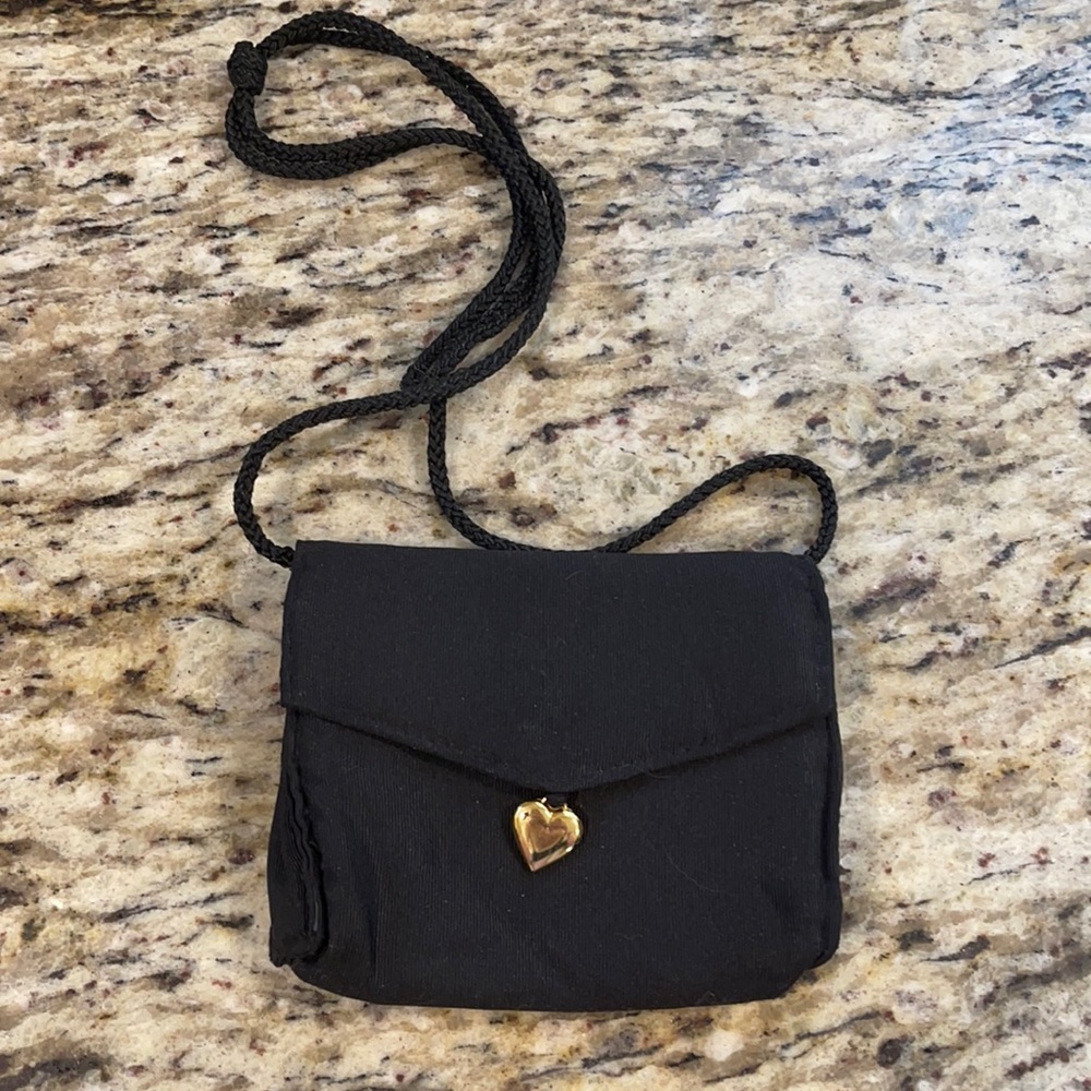 A black crossover bag with heart
